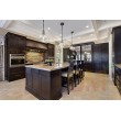 Black Shaker cabinetry with Glass door pantry in upscale home 